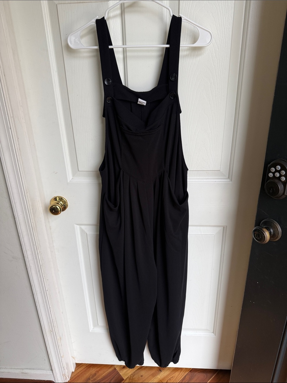 HALARA Black Sleeveless Jumpsuit with Button-Strap Pockets